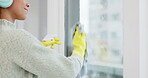 Headphone, window and woman spring cleaning a glass door in home living room as for hygiene, protection or disinfection. Dirt, dust and person or cleaner doing domestic or sanitary housekeeping work