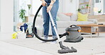 Person, vacuum and cleaning carpet in living room for housekeeping, hygiene or dirt and dust removal at home. Maid, domestic or cleaner with machine and equipment on floor rug or interior service