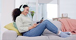 Happy woman, headphones and phone with credit card in online shopping, payment or banking on living room sofa at home. Female person shopper smile in relax on mobile smartphone, bank app or ecommerce