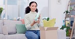 Woman, box and headphones in delivery, online order or ecommerce on living room sofa at home. Happy female person unboxing new headset in parcel, package or cardboard cargo shipment on couch in house