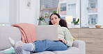 Woman relax, sofa and computer for home internet, e learning and online education or movie streaming service. Young african person on couch, laptop and living room with remote work, website and blog