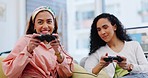 Video games, friends and women playing together on home sofa for fun, competitive contest or esports. Gamer people with controller in lounge to celebrate win with technology, dance and entertainment