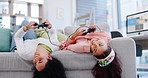 Women friends, couch and controller for gaming together, relax or online challenge in home living room. Girl, video game and excited people on sofa, lounge or thinking of strategy, contest or esports