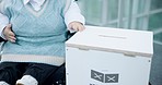 Ballot box, vote and person with disability in election for politics and change by voting. Democracy, hand and paper with choice, decision and support for political party for government campaign
