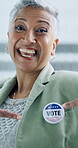 Face, vote and an excited woman pointing to a badge in support of freedom or democracy in politics. Portrait, happy and proud of her choice, decision or selection of political party in the election