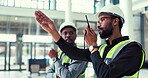 People, teamwork and engineer talking on a walkie talkie for project management and planning. Construction, maintenance and inspection with black men or staff at office building with communication