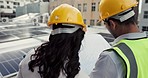 Engineering, planning and team of construction workers with blueprint on the rooftop of a building. Discussion, collaboration and industrial employees working with an architecture design in the city.