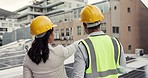 Construction, planning and team of engineers in the city on the rooftop of building for inspection. Discussion, collaboration and back of industrial employees working with architecture design in town