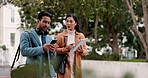 Technology, business people and walking together outdoor for travel and chat in city. Professional man and woman with a phone and tablet on journey on urban road for communication, networking and app