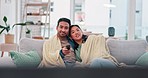 Watching tv, movies and a couple on a home sofa with a remote control for choice and relax. Asian man and a woman together on a couch for streaming subscription, show or series with comfort and care