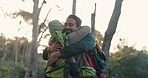 Hiking, high five and couple hug in in a forest for fitness, travel and freedom celebration in nature. Backpacking, success and people with hands together for victory, achievement or jungle milestone