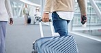 Walking, back and hands on luggage in airport to travel, vacation or holiday in airline lobby. Suitcase, person and rear of man on flight terminal, immigration journey or international airplane trip