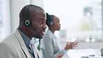 Call center, telemarketing and male consultant in the office doing an online consultation. Contact us, crm and young African man customer service agent working on a hotline with headset in workplace.