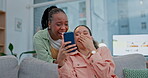 Woman, friends and laughing with phone in funny joke, social media or post together on living room sofa. Female person or people smile in happiness, humor or meme on mobile smartphone app at home