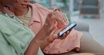 Couple of friends, phone and women on a home sofa for online shopping, website and internet. Hands, lesbian people and talking on a couch with a smartphone for communication, search or social media