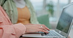 Hands, laptop and a woman designer typing in the office closeup for research of a report or project. Computer, email and communication with an employee working online for the company newsletter