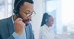 Computer, customer service and a black man consultant working in a call center for support or assistance. Contact, crm and headset communication with an employee consulting in a telemarketing office