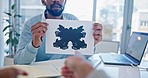 Therapist man, inkblot paper and analysis with patient pointing, test or help for mental health in clinic. Psychologist, document and painting for Rorschach exam, consulting or support for healthcare