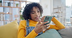 Phone, social media and relax with a woman on a sofa in the living room of her apartment for communication. Mobile, contact and app with a young person typing or reading a text message in her home