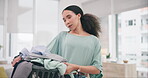 Laundry, portrait and woman with washing clothes and cleaning in a home living room doing housework for hygiene. Basket, service and young tidy person or cleaner working on household task in a lounge