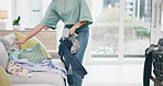 Cleaning, living room and person with laundry basket at home with maid work and housekeeping. Cleaner and clothing for washing in a house with job in a lounge at morning with helping from worker