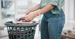 Laundry, hands and woman packing clothes and cleaning in a home living room doing housework for hygiene. Sorting, closeup and young tidy person or cleaner working on household task in a lounge