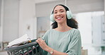 Laundry, headphone and portrait of woman with clothes and cleaning in home living room doing housework for hygiene. Sorting, smile and young tidy person or cleaner working on household task in lounge