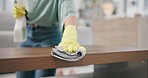 Housekeeping, products and woman cleaning the furniture with detergent, cloth and gloves. Closeup of female maid, cleaner or housewife wipe the table with dirt, dust or bacteria for hygiene at home.