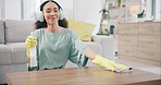 Housekeeping, dancing and woman cleaning with headphones for music, playlist or radio. Female maid, cleaner or housewife listening to song to wipe the table with detergent, cloth and gloves at home.