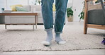 Feet, dance and broom with a person cleaning a carpet in the living room of a home for housework. Legs, freedom and energy with an adult in an apartment closeup for routine housekeeping or sweeping