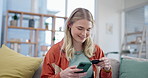 Woman, credit card and phone for online shopping in home with digital payment, fintech and finance of money. Happy person on sofa for mobile banking, ecommerce and password for sales on financial app