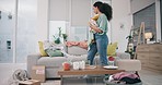 Cleaning, living room and woman at home with maid work and housekeeping maintenance. Cleaner, laundry and clothing for washing in a house with job in a lounge at morning with helping from worker