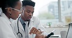 Tablet, conversation and team of doctors in an office in the hospital for a diagnosis treatment plan. Healthcare, discussion and African medical workers doing research on digital technology in clinic