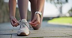 Fitness, shoes and hands on woman with lace tie in a road for running, workout and training outdoor. Start, feet and female runner prepare for wellness workout, performance and weekend sports routine