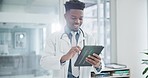 Research, tablet and a doctor black man in the hospital for healthcare or innovation in modern treatment. Medical, technology and data with a happy medicine professional in a clinic for breakthrough