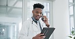 Tablet, phone call and a doctor black man in the hospital for research or innovation in modern treatment. Medical, healthcare and information with a happy medicine professional talking in a clinic