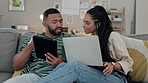Couple, sofa and tablet or laptop for planning, streaming service and subscription decision at home. Young people relax on couch, digital technology and computer for social media FAQ and information