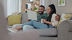 Couple, laptop and relax with coffee on sofa in living room for love, movies and streaming internet show. Happy woman, man and hug with computer on social media, subscription blog and online shopping