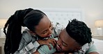 Black couple in bed with playful embrace, love and relax on weekend morning in home. Smile, hug and fun, African man and happy woman in bedroom together, laughing and bonding in apartment with care.