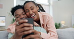 Couple, hug and phone on home sofa while streaming, online shopping and happy in a lounge. Black man and woman relax on a couch with a smartphone for internet, social media and funny meme or video