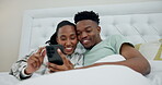 Phone, social media and a black couple in bed together to relax in their home on a weekend morning. App, love or smile with a man and woman looking at a meme on a mobile while in the bedroom