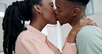Home, kiss and black couple with love, support and romance with trust, dating and relationship. Romantic, man and woman kissing, marriage anniversary and happiness with bonding and hug in a lounge