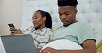 Laptop, phone and black couple relax in bed with tech, network connection or search on social media for news or info. People, online and mobile app user typing or reading on internet in bedroom