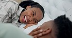 Laughing, care and a black couple on a bed for conversation, love and communication. Relax, happy and an African woman with a man in a home bedroom for talking, bonding and together in the morning