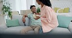 Black couple on sofa with popcorn, watching tv and smile on date night together in living room. Relax, African man and happy woman eating snacks on couch with television show subscription or movies.