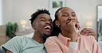 Black couple on sofa with popcorn, watching tv comedy and date night together in living room. Relax, African man and happy woman eating snacks on couch with laughing, comic show and funny movies.