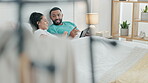 Couple, smile and communication with tablet in bed for online shopping, streaming multimedia show and search blog. Man, woman and conversation with digital technology, social media and app in bedroom