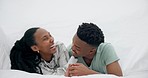 Black couple, bed and laughing with happy love under a bedroom blanket in the morning at home. Smile, funny and young people together with support and care in house with commitment ready for a kiss 