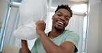 Happy black man, pillow fight and playing in bed, POV or fun bonding relationship together at home. Portrait of African male person play fighting with cushion in morning happiness in the bedroom