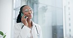 Phone call, doctor and black woman in hospital for conversation, consulting or telehealth service. Healthcare, clinic and happy surgeon talk on smartphone for communication, medical support or advice